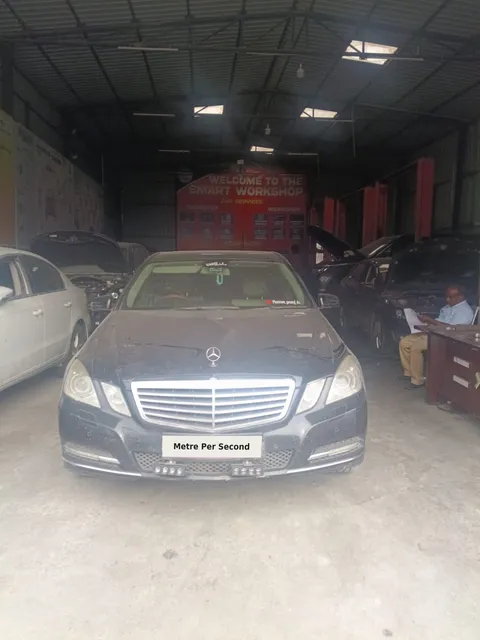 Black Mercedes-Benz E-Class inside the Metre Per Second workshop