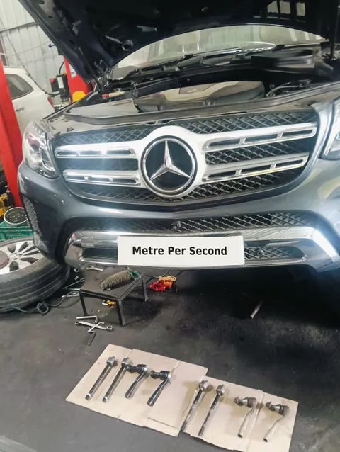 Mercedes-Benz GLS with steering components laid out for workshop inspection