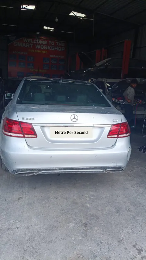 Silver Mercedes E-Class on the Metre Per Second workshop floor