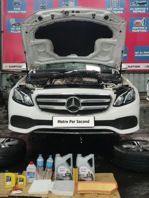 Mercedes-Benz with oil containers and service filters laid out in front