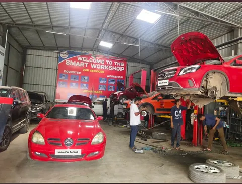 Mercedes-Benz vehicles and technicians inside the Metre Per Second workshop with registration numbers replaced by Metre Per Second