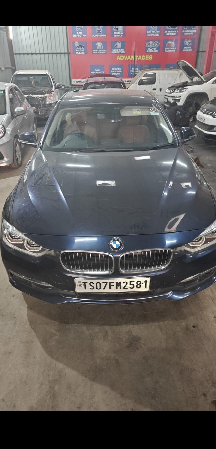 Car on lift for full inspection at MPS workshop, KPHB Hyderabad