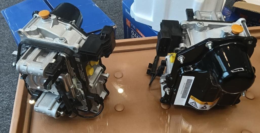 DSG mechatronic units viewed from different sides on a workshop bench